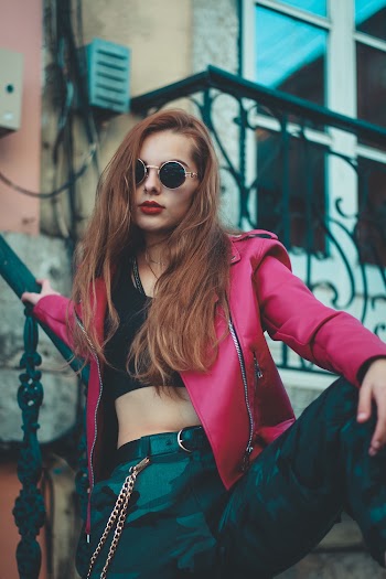 Woman in Red Leather Jacket Leaning on Stairs