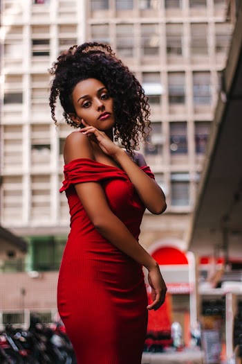 Woman in Red Off-shoulder Dress Near Building
