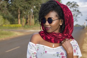 Woman in Red Scarf Standing on the Road