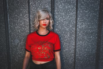 Woman in Red Shirt Standing Near Wall
