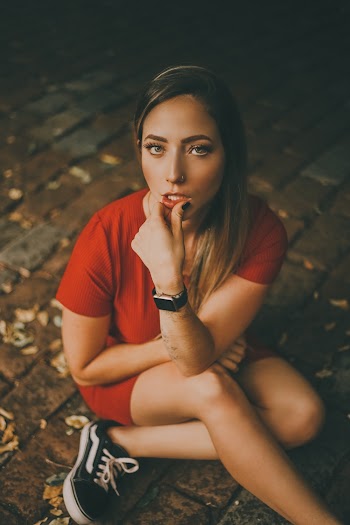 Woman in Red Short-sleeved Dress Sitting on Ground
