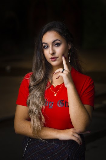 Woman in Red T Shirt Touching Her Face