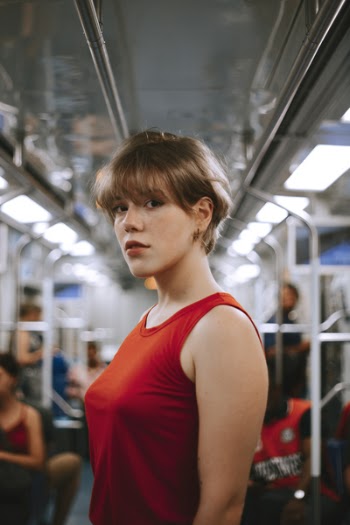 Woman In Red Tank Top Standing Inside Train