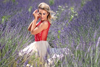 Woman in Red Tank Top With White Mini Skirt Sitting on Grape Purple Hyacinth Field during Daytime