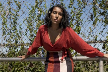 Woman In  Red Top And Striped Skirt