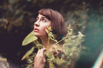Woman in Red Top Near Green Plants