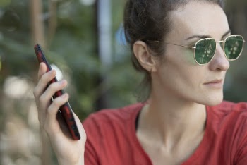 Woman in Red Top Wearing Sunglasses Holding Smartphone