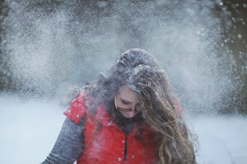 Woman in Red Vest With Snow on Her Head