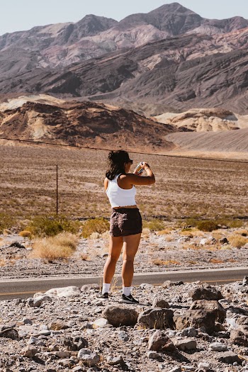 Woman in Shorts Standing Near Mountain