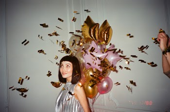 Woman in Silver-blouse Holding Balloons