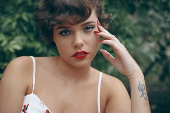 Woman in Spaghetti Strapped Dress Wearing Red Lipstick And Red Nail Polish