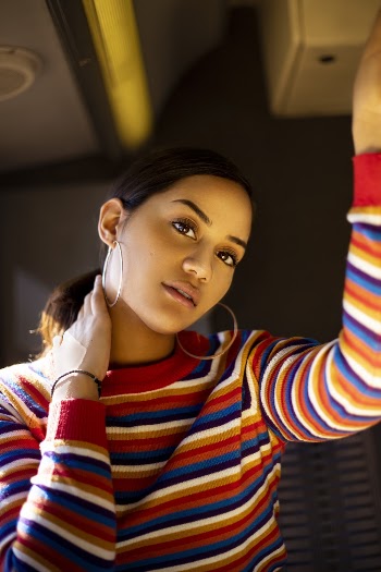 Woman In Striped Long Sleeved Top