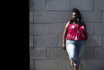 Woman In Summer Fashion Leans On Wall