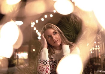 Woman in Sweater by String Lights