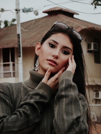 Woman In Sweater Wearing Eyeglasses