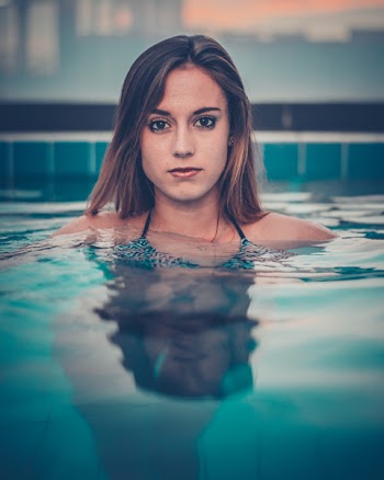 Woman in Swimming Pool Near Tiles