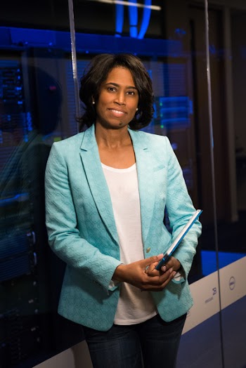 Woman in Teal Blazer Coat and Black Pants Holding A Tablet