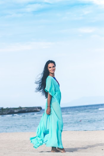 Woman in Teal Dress on Seashore