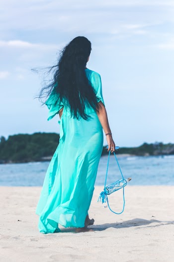 Woman in Teal Dress Standing on Beach