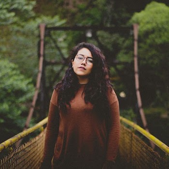 woman in the middle of bridge standing