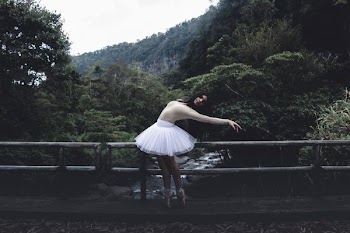 woman in tutu dress on bridge