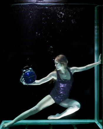 Woman in Underwater Holding Round Blue Analog Bell Alarm Clock