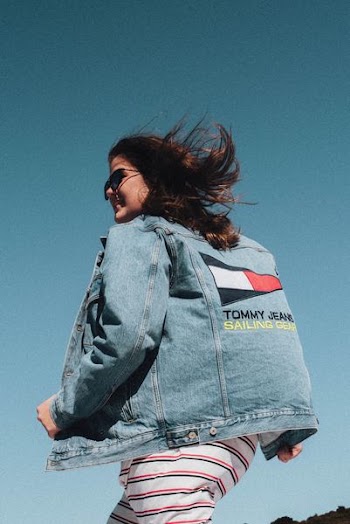 woman in walking gesture under blue sky