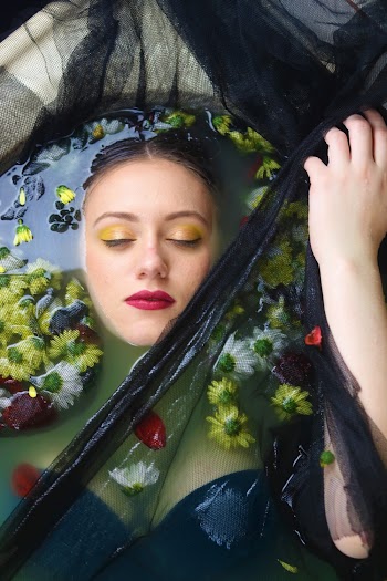 Woman in Water With Flowers