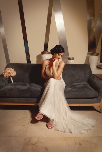Woman In Wedding Gown Sitting On Sofa