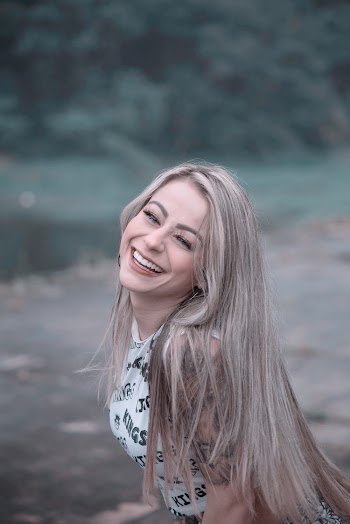 Woman in White and Black Sleeveless Top Smiling