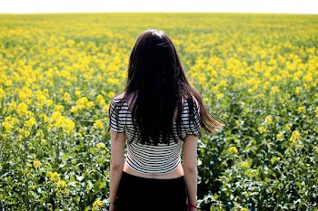Woman in White and Black Striped Crop Top Facing Field 