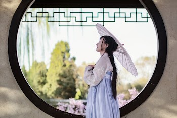 Woman In White And Blue Long Sleeve Dress Near Window