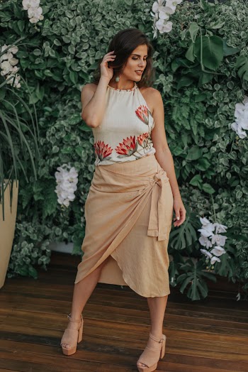 Woman in White and Brown Dress Standing Behind Grass Backdrop
