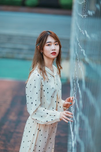 Woman in White and Gray Long-sleeved Collared Dress