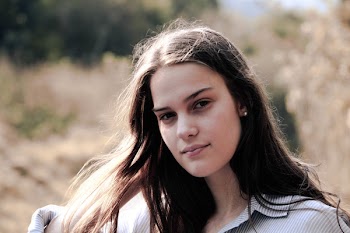 Woman in White and Grey Pinstriped Collared Shirt Posing for Photo