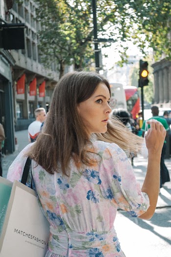 Woman in White and Pink Floral Dress on Sidewalk