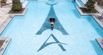 Woman in White Bikini Standing on Swimming Pool