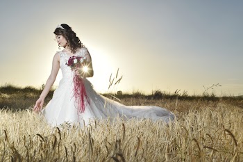 Woman in White Bridal Gown Standing in a Feld