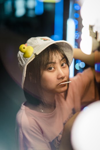 Woman in White Bucket Hat and Pink Shirt