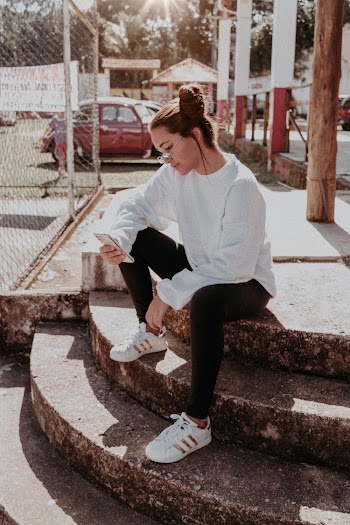 Woman in White Crew-neck Long-sleeved Shirt Sitting on Stairs