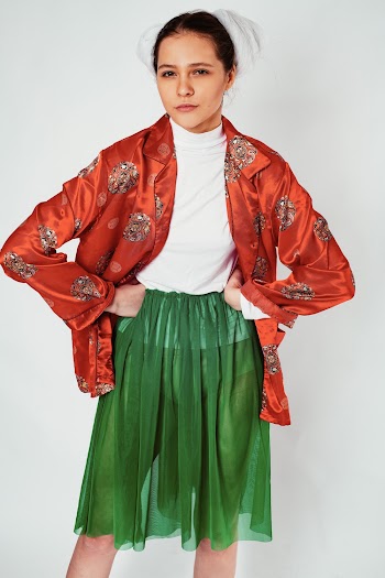 Woman in White Crew-neck Shirt and Green Skirt Standing in Room