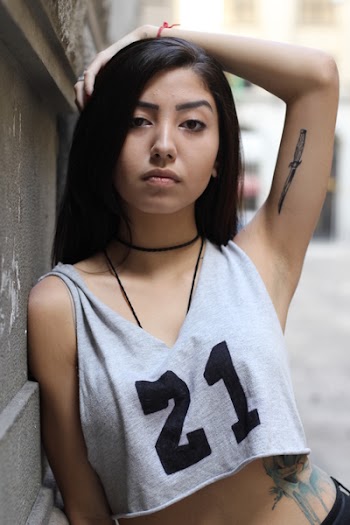Woman in White Crop Top Putting Her Left Arm over Her Head