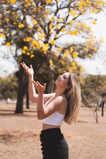 Woman in White Crop-top Standing Near Tree