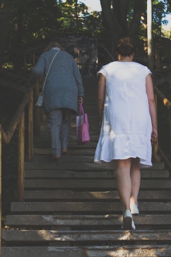Woman in White Dress Climbing the Stairs