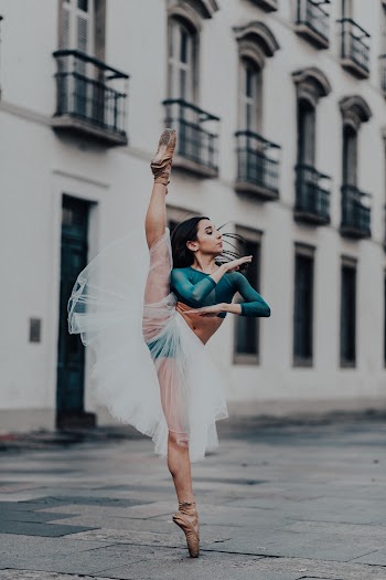 Woman in White Dress Dancing on Street
