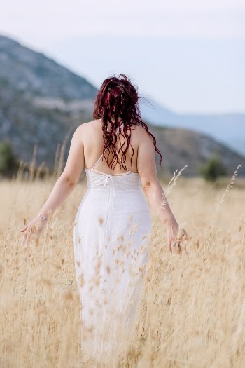 Woman in White Dress in Field