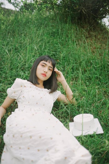 Woman in White Dress Lying on Green Grass Field · Free Stock Photo