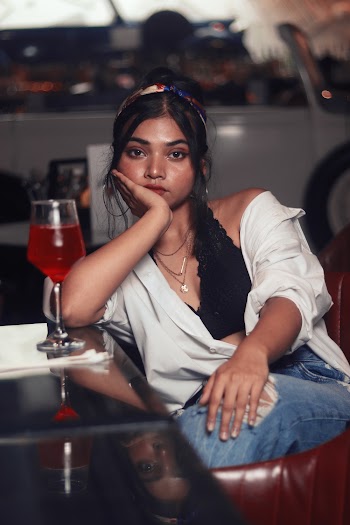Woman in White Dress Shirt Resting Face on Right Palm