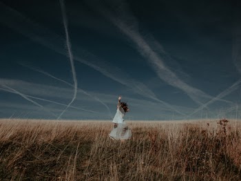 Woman in White Dress Standing on Plant Field