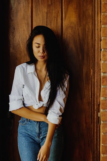 Woman In White Front-tie Crop-top And Blue Jeans